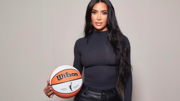 Kim Kardashian holds a WNBA basketball in a photo shoot.
